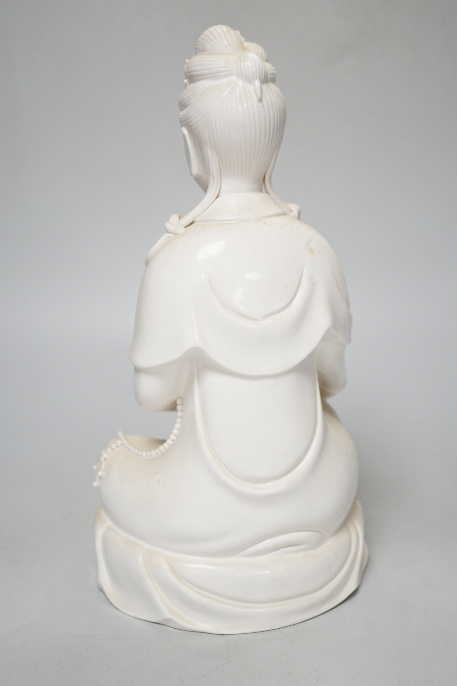 A blanc de chine figure of Guanyin and a child, 27cm